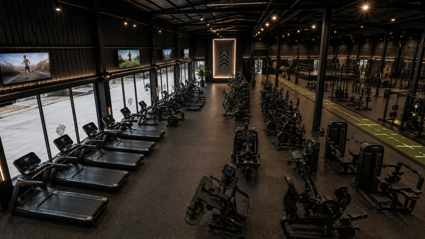 Aerial view of the main training hall with treadmill rows, turf strip and boxing ring